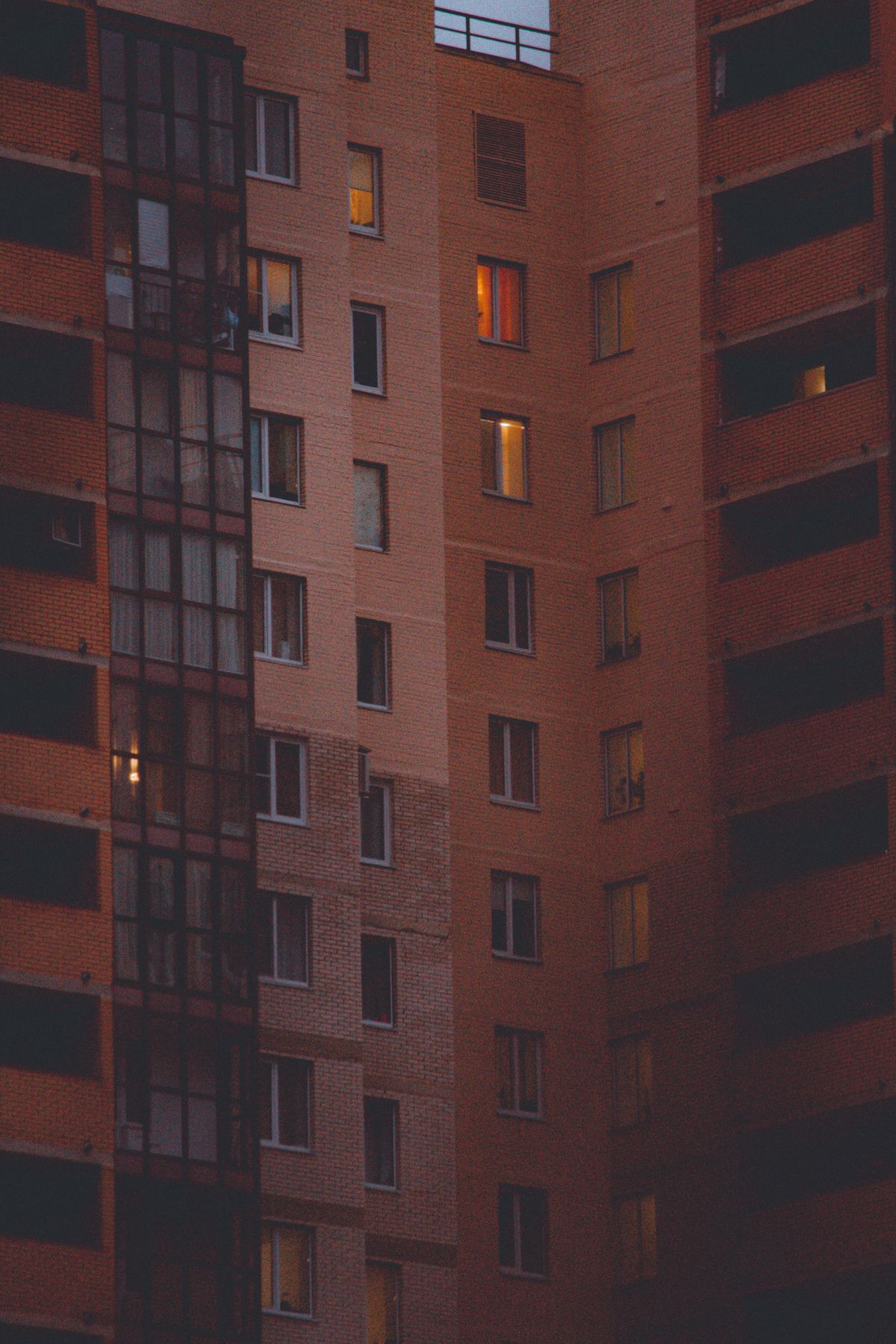 Apartment windows illuminated at dusk